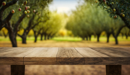 Empty wooden table with a background of blurred fruit trees.