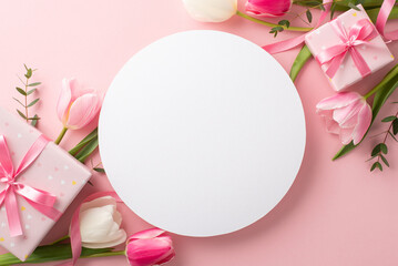 Mother's Day celebration concept. Top view photo of white circle gift boxes with bows and tulips on isolated pastel pink background with blank space