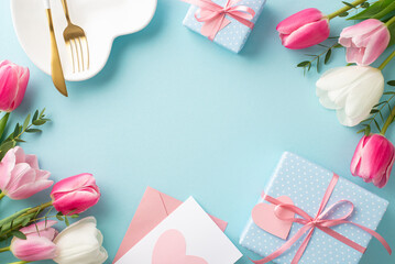 Mother's Day concept. Top view photo of heart shaped plate cutlery white and pink tulips gift boxes...