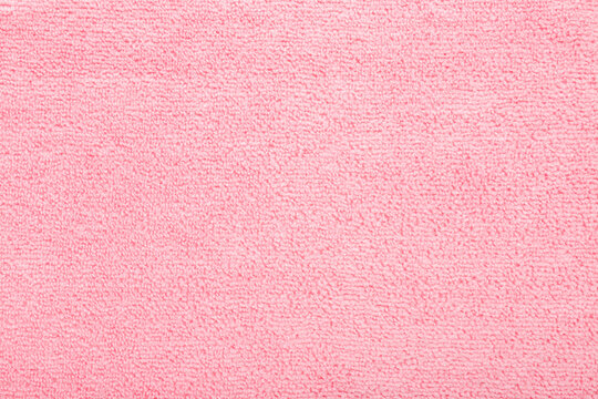 Light pink dry soft microfiber rag background. Closeup. Pastel color. Empty place for text. Top down view.