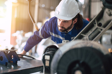 Engineer technician team service checking heavy industry machine robot welding arm head maintenance