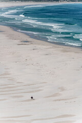 lone rider on white sands of Long Beach at Kommetje, Cape Town