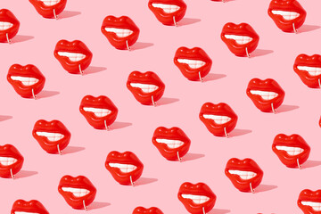 Beautiful pattern made of sensual red lips with piercing ring on pink background.