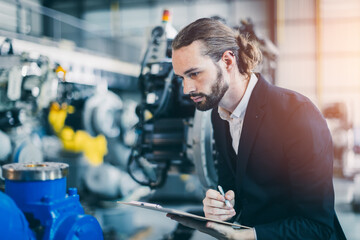 Businessman manager in suit working in machinery factory robot assembly plant looking check products inventory for industry products business