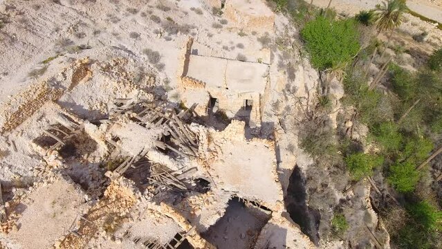 The Ghoufi canyon in Biskra with the Abio river surrounded by palm trees and ruin. Algeria Batna