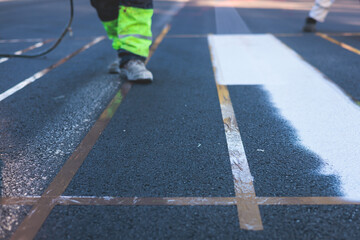 Process of making new road surface markings with a line striping machine, workers improve city...
