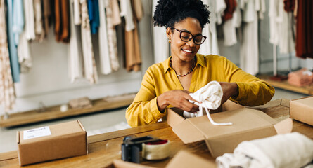 Female dropshipper fulfils quality clothing orders, making success in the ecommerce business - obrazy, fototapety, plakaty