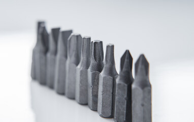 Set of heads for screwdriver (bits) Tools collection copy space, close up, selective focus. blurred dark background