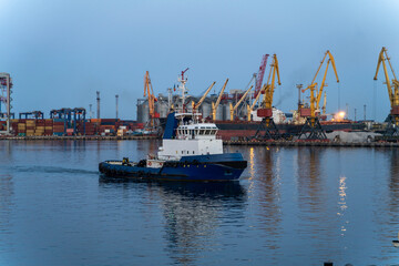 Large tugboat moves in port area