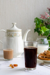 breakfast on the table: coffee pot, cup of coffee, bagels, sugar, beautifully served table