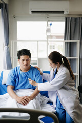 Obraz premium Asian male patient on bed while doctor hands of checking examining his pulse for record the treatment results in hospital