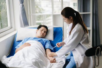 Fototapeta premium Doctor discussing treatment with male patient talking and laughing sitting on examination bed in clinic or hospital.