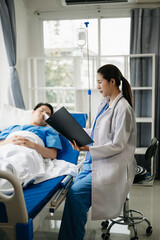 Obraz premium Doctor discussing treatment with male patient talking and laughing sitting on examination bed in clinic or hospital.