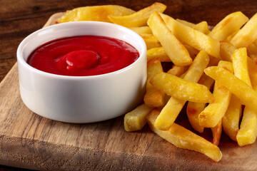 French fries, potato snack with a dip, fast food on a wooden table, a side dish
