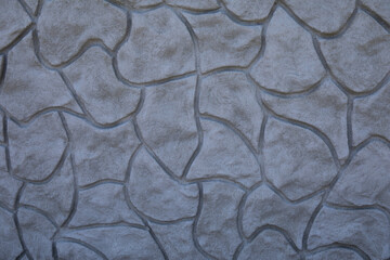 Wall facade made with concrete in rubble stone shape decoration.