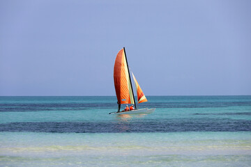 View to sailboat on blue ocean surface. Background for holidays on a sunny beach