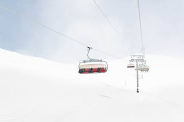 path of the cable car to the snow-capped mountains with a beautiful view in partly cloudy day