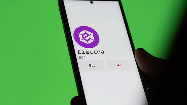 March 11 2023 London UK. An investor's analyzing the Electra  coin on screen. A phone shows the crypto's prices to invest in ECA