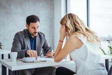 Mad male worker yelling at female colleague asking her to leave office, multiracial coworkers disputing during business negotiations, employees cannot reach agreement, blaming for mistake or crisis