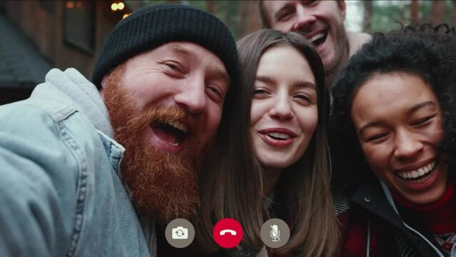 Smiling multinational friends talk via video call on the phone in the forest