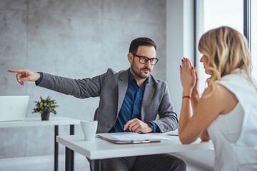 Obraz premium Director dissmissing worker. Getting fired. Angry boss pointing female employee on exit way. Mad male employee blaming female colleague for mistake. Get out of here. 