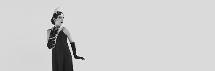 Banner of scared chic woman wearing vintage old-style clothes and looking with full of fear eyes away. Monochrome. Copy space for ad