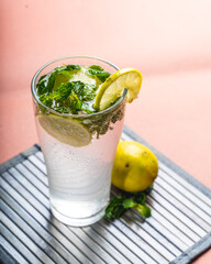 fresh virgin mojito in a glass with lemon on top