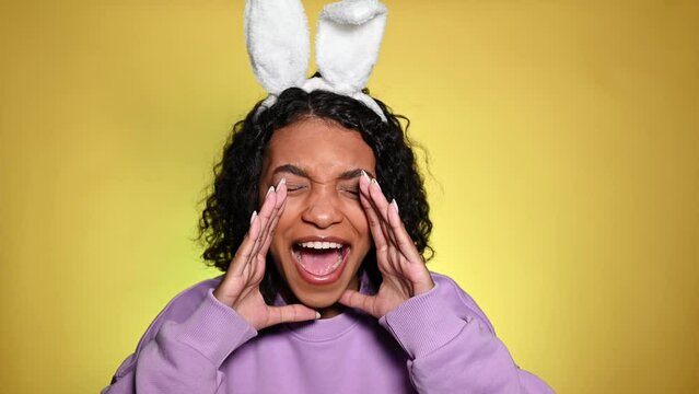 Happy african american girl screaming or shouting to attract attention. Spring easter sale concept