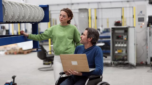 Social integration in the workplace leads to a more inclusive and collaborative environment between colleagues - male and female engineers in the robotics factory -