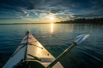 Silent serenity amidst a stunning sunset - kayaking through the breathtaking beauty of Scandinavia's tranquil lakes