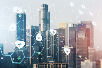 Double exposure of abstract virtual medical hologram on Los Angeles city skyscrapers background....