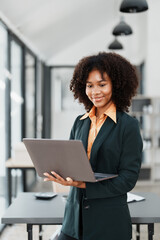 Beautiful young teen American African holding computer laptop with planning working on financial...