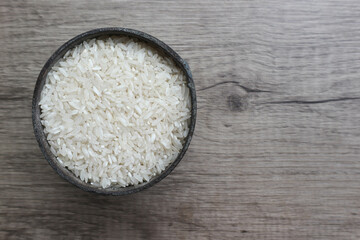 White Rice, rice in the iron container on the wooden background