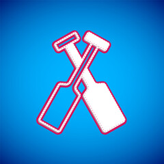White Crossed oars or paddles boat icon isolated on blue background. Vector