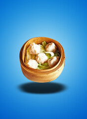 Floating Bamboo basket with five cooked Dim Sum on blue gradient