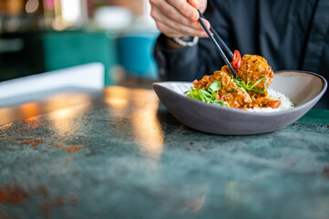 man hand eat chicken curry rice holding chopsticks