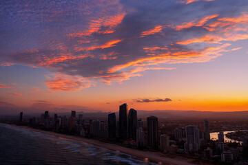 Colouful aerial sunset view over Gold Coast skyline and beach	