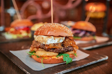 Healthy burger vegan and nonvegan style food dish. Restart burger sets on wooden plate. Meaty juicy...