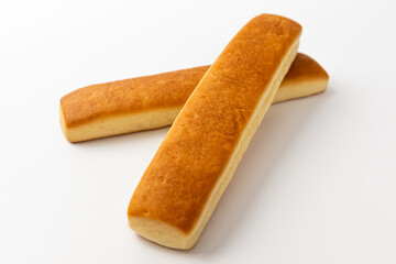 Bread sticks with butter on a white background