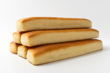 Bread sticks with butter on a white background