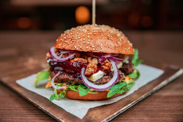 Healthy burger vegan and nonvegan style food dish. Restart burger sets on wooden plate. Meaty juicy...