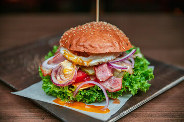 Healthy burger vegan and nonvegan style food dish. Restart burger sets on wooden plate. Meaty juicy burgers with vegetables. Culinary made dish. closeup shot and wide shot. Ham. Unhealthy junk food. 