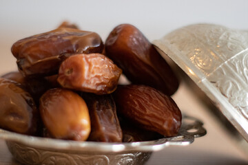 A bowl of dates with a white background