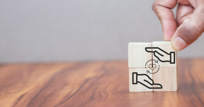 Customer relationship management (CRM) or customer loyalty concept. Customer satisfaction, retention strategies. CRM or customer loyalty program banner. Hand put wooden cubes with holding heart icon