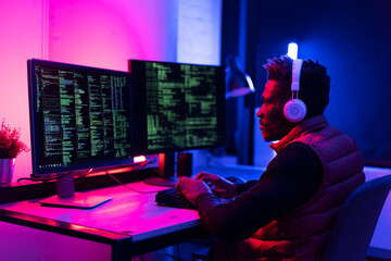 Software developer coding on his computer. Coding and hacking concept