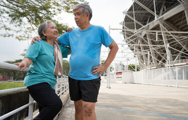 Happy and smile couples elderly asian standing on stairs for rest after workout, jogging on morning, senior exercise outdoor for good healthy. Concept of healthcare and active lifestyle for healthy