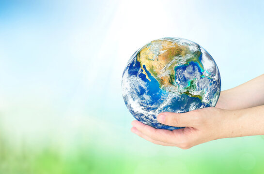 earth day concept, Human hands holding earth global on blurred nature background. Elements of this image furnished by NASA