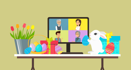 Easter family holiday, table with computer, white bunny,egg and gift. Video conference with people group on compuer, meeting online. Friends, colleagues talking on video and celebrating Easter day