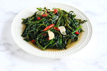 stir fried water spinach, typical food Indonesia java.  cah Kangkung
