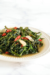 stir fried water spinach, typical food Indonesia java.  cah Kangkung
